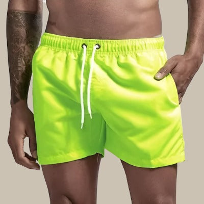 Men's quick-dry swim shorts featuring an adjustable waist, designed for comfort and style, perfect for beach outings and pool days. 0